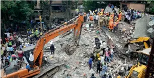 ?? AP ?? Rescuers work on the debris after a building collapsed in the Ghatkopar area of Mumbai. —