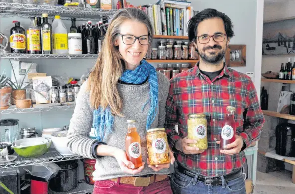  ?? SARA ERICSSON ?? Seven Acres Farm owner Jocelyn Durston stands with her partner and fellow fermenter Chris Kasza with their fermented products in their kitchen, which doubles as their current work space. The duo is looking at expanding into a commercial kitchen as...