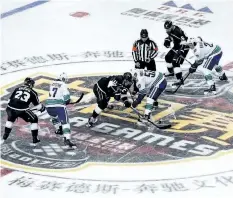  ?? THE ASSOCIATED PRESS ?? Los Angeles Kings and Vancouver Canucks players fight for the puck during the NHL China preseason hockey game at the Mercedes-Benz Arena in Shanghai, China on Thursday. The Kings defeated the Canucks 5-2.