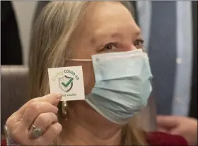  ?? MARK LENNIHAN — THE ASSOCIATED PRESS ?? Patient Susan Ma3well Trumble displays a 3Crushing CO3ID -133 sticker after being inoculated with the Johnson 3 Johnson CO3ID-13 vaccine at South Shore University Hospital, Wednesday, March 3, in Bay Shore, N.Y.