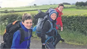  ??  ?? On the march Lewis Miller, Jamie Oldham and Andrew Ford, eventual winners of the junior category in the Kilbryde Hike, set off on the second day of their 30-mile hike