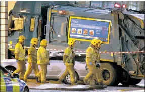  ??  ?? AFTERMATH: Firefighte­rs working at the scene of the fatal crash