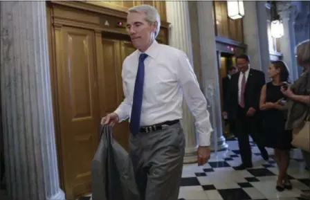  ?? J. SCOTT APPLEWHITE — THE ASSOCIATED PRESS ?? Sen. Rob Portman, R-Ohio, arrives for a vote as the Republican-run Senate rejected a GOP proposal to scuttle President Barack Obama’s health care law and give Congress two years to devise a replacemen­t, Wednesday at the Capitol in Washington. President...