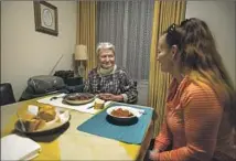  ?? ?? CAREGIVER Helen Major, right, serves a traditiona­l Hungarian dish to Hideg. They both came to the U.S. from that country.