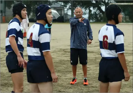  ??  ?? England head coach Eddie Jones coaching students at Tsurumigao­ka High School yesterday. Picture: Getty