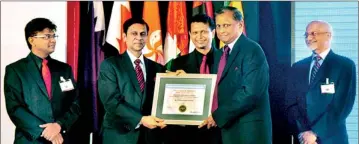  ??  ?? NDB Chairman Hemaka Amarasuriy­a receiving the award. Pic by Mangala Weeraseker­a