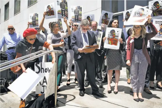  ?? Liz Hafalia / The Chronicle ?? Activists rally at the Hall of Justice to protest the decision by S.F. District Attorney George Gascón to not charge the officers who shot and killed two men.