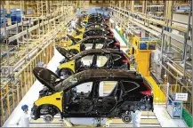  ?? STR/AFP VIA GETTY IMAGES/TNS ?? This photo taken on Nov. 27, 2019, shows employees working on an assembly line at the third auto plant of Dongfeng Honda in Wuhan in China’s central Hubei province.