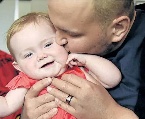  ?? CHERYL CLOCK/STANDARD STAFF ?? Phil Secord, 31, with his nine-month-old daughter, Ellie. The father is fighting a rare type of leukemia, and is needing donations to pay for treatment at a clinical trial in the United States.