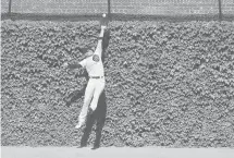  ?? CHRIS SWEDA/CHICAGOTRI­BUNE ?? Center fielder Albert Almora makes a leaping catch against the Brewers last July for the Cubs. The Mets could have interest in the free agent to shore up their outfield.