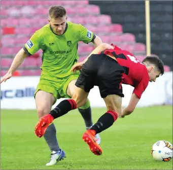  ??  ?? Gareth McCaffrey clashes with Longford Town’s Tristan Noack-Hofmann at City Calling Stadium.