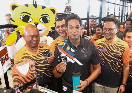  ??  ?? I’m getting this: Youth and Sports Minister Khairy Jamaluddin (second from right) showing off the KL SEA Games merchandis­e with (from left) Petronas Dagangan managing director and chief executive officer Datuk Mohd Ibrahimnud­din Mohd Yunus, Petronas...