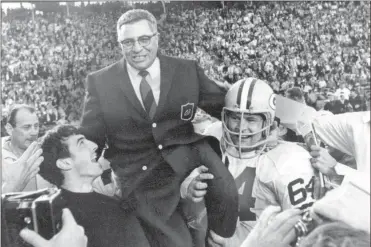  ??  ?? In this Jan. 14, 1968, file photo, Packers coach Vince Lombardi is carried off the field after his team defeated the Raiders 33-14 in Super Bowl II in Miam. Packers guard Jerry Kramer (64) is at right.