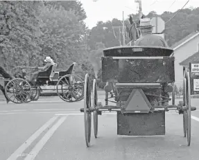  ?? [MIKE SCHENK/WOOSTER DAILY RECORD] ?? Amish transporta­tion comes in different shapes as these two open surreys show.