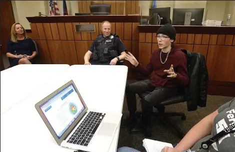  ?? Jenny Sparks / Loveland Reporter-herald ?? Ferguson High School student Dylan Brady, center right, talks about his experience with the new Rise Above alternativ­e sentencing program Monday at the Loveland Police and Courts building. Loveland Police Officer and Ferguson school resource officer Doug Savage, center left, started the program and Ferguson teacher Krissie Lockard, far right, helps run it. Loveland Municipal Judge Geri Joneson, left, says the program is a good tool for her to be able to use during sentencing.