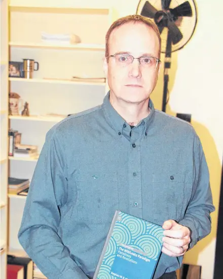  ?? Richard Mackenzie ?? St. F.X. Sociology Department associate professor Stephen Marmura holds a copy of his book The Wikileaks Paradigm: Paradoxes and Revelation­s, which will receive an official launchJan. 25, during an afternoon event.