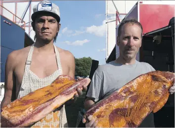  ?? KAYLE NEIS ?? Jeffrey Mercredi and Ronnie Tate show off seasoned brisket that'll be hitting the grill at RibFest at Diefenbake­r Park. The fifth annual event will see skilled barbecue chefs cook up a storm over the long weekend