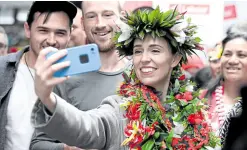  ?? — REUTERS ?? SUPERSTAR Newzealand’s Prime Minister Jacinda Ardern takes pictures with supporters. Her Labor Party has won 49 percent of votes cast on Saturday.