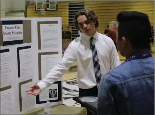  ?? Brennon Dixson/The Signal (See additional photos at signalscv.com) ?? Valencia High School freshman Christophe­r Cotti presents his final project to alumnus Mathew Martinez during the inaugural MSA Day. More than 150 students joined industry profession­als, community leaders and district officials on Wednesday to...