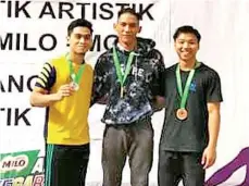  ??  ?? Izzat poses at the podium after winning the MAG Senior Vault event.