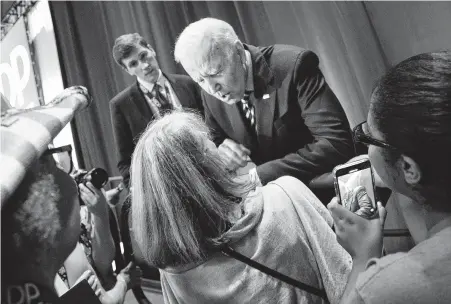  ?? Tracy Glantz / Associated Press ?? Former Vice President Joe Biden greets supporters during the South Carolina Democratic Convention in Columbia, S.C. Pictured below are, from left, Democratic candidates Elizabeth Warren, Cory Booker and Kamala Harris.