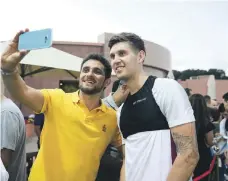  ??  ?? Competitio­n winner Youssef Badr takes a selfie with City defender John Stones at Emirates Palace