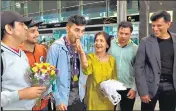  ?? ANI ?? Lakshya Sen (3rd from left) is being welcomed by his family at the Bengaluru airport as his coach Vimal Kumar (R) looks on.