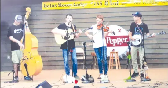  ?? MARJORIE COMEAU ?? Tyler's youth band included (from left to right), Kyser George, on bass, from North Carolina, Presley Barker, on rhythm guitar, from North Carolina, Carson Peters, on fiddle, from Tennessee, and Tyler Comeau himself, on banjo, from Cowansvill­e.