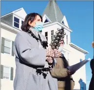  ?? Alyssa Seidman / Hearst Connecticu­t Media ?? Veterans Park Elementary School Principal Ellen Tuckner plays the jingle bells during a caroling concert in front of Town Hall on Monday in Ridgefield.