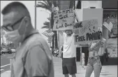  ?? JASON ARMOND/LOS ANGELES TIMES ?? Demonstrat­ors protest the COVID-19 lockdown in March. These days some protesters are targeting public health officials outside their homes.