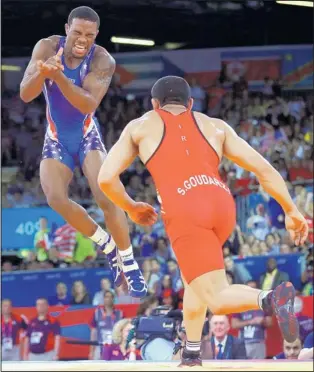  ?? PAUL SANCYA/THE ASSOCIATED PRESS ?? American Jordan Burroughs, left, celebrates after a winning move against Iran’s Sadegh Saeed Goudarzi during their gold-medal match in the 74-kg men’s freesstyle wrestling event Friday.
