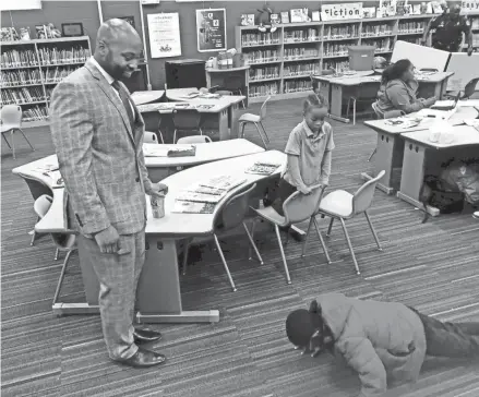  ?? JAMES E. CAUSEY/MILWAUKEE JOURNAL SENTINEL ?? Xavier Purdy, 33, was a first-time participan­t in Fatherhood Fridays. Purdy is with I’zaa Bryant and Tyrell Kirkwood, who is doing pushups.