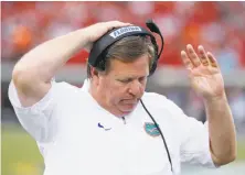  ?? Joe Robbins / Getty Images ?? Beleaguere­d Jim McElwain made his final coaching appearance for Florida in a 42-7 loss to Georgia on Saturday.