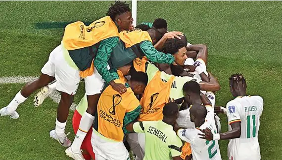  ?? Photo: AFP ?? Kalidou Koulibaly was mobbed by teammates after scoring Senegal’s winner against Ecuador.