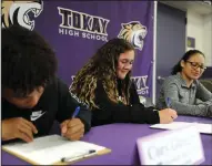  ?? BEA AHBECK/NEWS-SENTINEL ?? Tokay High athletes Cory Glasgow, Zoe Offield and Jazmin Ruiz sign at Tokay High in Lodi on Wednesday.