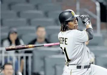  ?? JOHN BAZEMORE/ THE ASSOCIATED PRESS ?? Pittsburgh Pirates’ second baseman Gift Ngoepe follows through on a game- winning two- run double in the 10th inning of a baseball game against the Atlanta Braves, on May 24. The Toronto Blue Jays made a move on Monday night to shore up their middle...