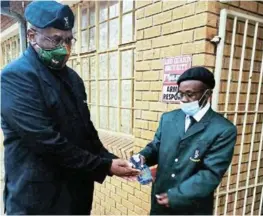  ?? Picture: SUPPLIED ?? FIGHITING THE VIRUS: The South African Military Veterans Chris Hani District have introduced a programme to help schools fight the Covid-19 pandemic in schools. Chairperso­n Sipho Ngwetsheni, left, and Lucas Mase, right, who is a former uMkhonto we Sizwe (MK) combatant and a South African National Defence Force navy officer were enforcing compliance at John Noah High School