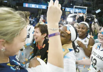  ?? BRIAN CASSELLA/ CHICAGO TRIBUNE ?? Notre Dame Fighting
Irish coach Muffet McGraw celebrates a win with her players April 1, 2019, at an NCAA Tournament regional final at Wintrust Arena in Chicago.