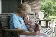  ?? PAUL VERNON — THE ASSOCIATED PRESS ?? Tressie Corsi sits with her great great granddaugh­ter Amelia Hollis on the porch of the house she has owned in Johnstown since 1972to that she is giving up to make way for an Intel manufactur­ing plant.