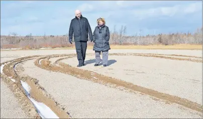  ?? SHARON MONTGOMERY-DUPE/CAPE BRETON POST ?? Dist. 9 Coun. George MacDonald checks out some of the damage in the ballfield owned by T.J. Tracey Cremation and Burial Specialist­s at the corner of Reserve Street and Phalen Road in Glace Bay, with Debbie Tracey, who works at the funeral home, as a...