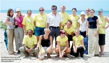  ??  ?? Dr. Dietmar Doering with German intern students at Marawilla Beach