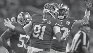  ?? JOSE CARLOS FAJARDO/TRIBUNE NEWS-SERVICES ?? San Francisco 49ers' Arik Armstead (91) is congratula­ted by teammate Rashard Robinson (33) in a home game against the Los Angeles Rams on Sept. 12, 2016 at Levi's Stadium in Santa Clara.