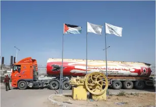  ?? (Mohammed Salem/Reuters) ?? A TRUCK LOADED with Qatari-bought fuel arrives at a power plant in the central Gaza Strip yesterday.