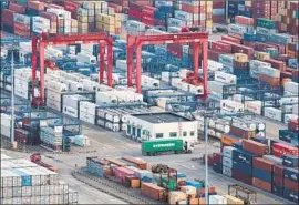  ?? Associated Press ?? SHIPPING CONTAINERS are stacked at Yangshan port in Shanghai. China’s export orders shrank in September amid an exchange of tariffs with the U.S.