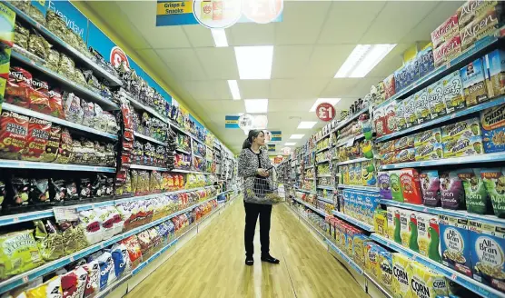  ?? Picture: GETTY IMAGES ?? BREXIT BREAKFAST: A customer browses in a Poundland store in Leigh. Steinhoff has increased its stake in the UK retailer