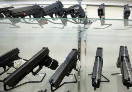  ?? ALAN DIAZ — ASSOCIATED PRESS FILE PHOTO ?? This June 29, 2016, file photo shows guns on display at a gun store in Miami. Support for tougher gun control laws is soaring in the United States, according to a new poll that found a majority of gun owners and half of Republican­s favor new laws to...