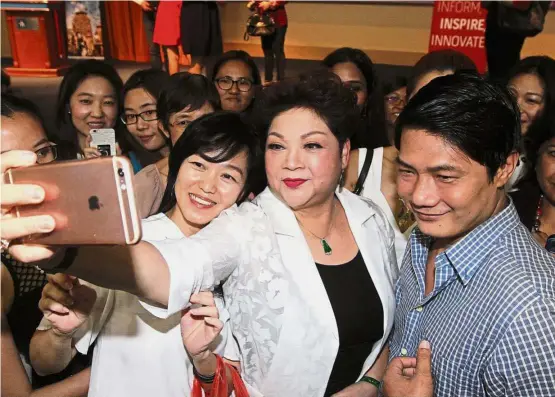  ??  ?? One for the album: Fans crowding around Cordero (in white jacket) for photograph­s during the WOW – Women do Wonders Talks and Bazaar at SEGi University Kota Damansara.