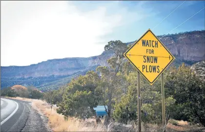  ?? MARLA BROSE/JOURNAL ?? A sign on N.M. 4 warning drivers of snow plows is instead surrounded by dry roads in the Jemez Mountains Wednesday.