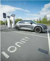  ?? CHRISTOPHE­R FURLONG/GETTY ?? A Hyundai Ioniq battery electric vehicle charges at an Ionity GmbH electric car charging station April 26 in Leeds, England.