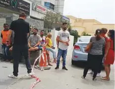  ?? Faisal Masudi/Gulf News ?? Residents of the fire-damaged Zen Tower in Dubai Marina wait to be allowed into their flats by officials at the scene.